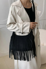 Suede Fringe Adjustable Strap Shoulder Bag worn with a trench coat, showcasing trendy fringe detail and adjustable strap in black.