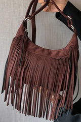 Suede Fringe Adjustable Strap Shoulder Bag with brown fringe design held by a model against a neutral background.
